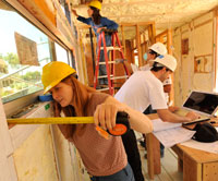Measure twice: CCA student Annessa Mattson, architectural project manager, in foreground, with Meez Perkins of CCA on the laptop and Mike Sizemore 