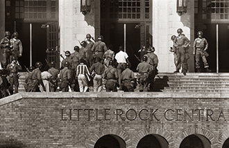 Members of the 101st Airborne escort African American students to school