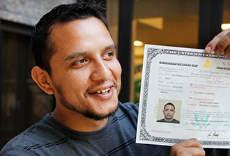 Daniel Torres holds a birth certificate