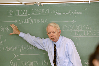 Eric Hanson stands before a chalkboard.