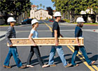 Students carrying an I-beam