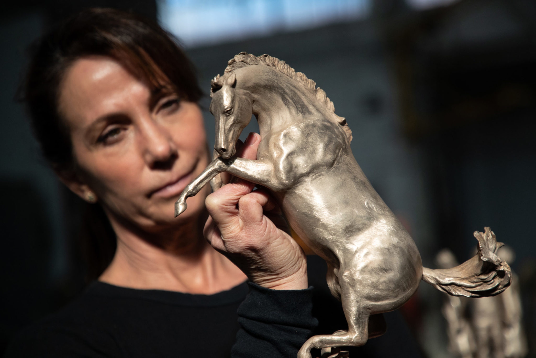 Timi Sobrato inspects sculpture