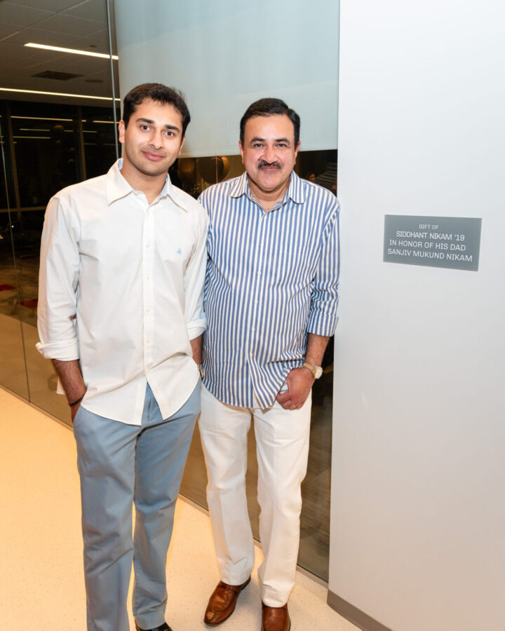 Siddhant Nikam ’19 and his father, Sanvij Nikam, outside the SCDI classroom named in Sanjiv’s honor.