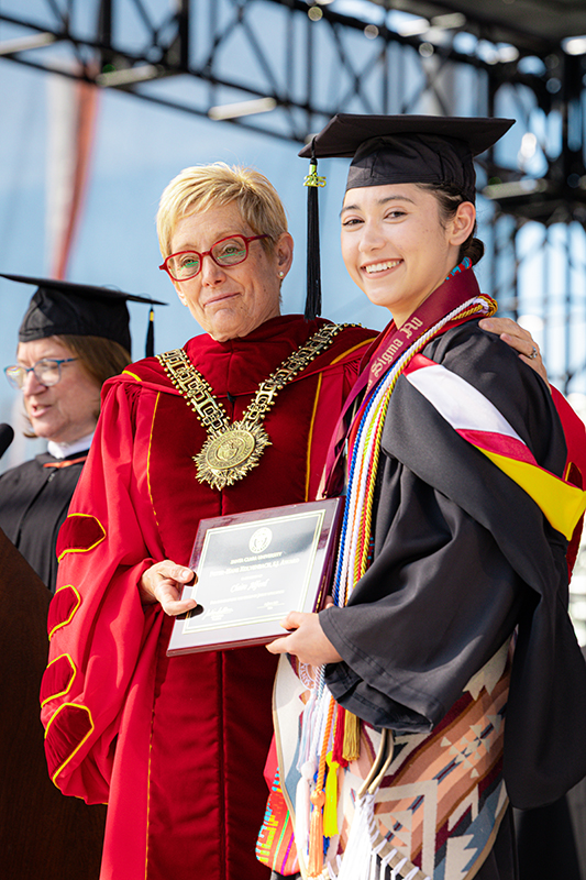 Santa Clara University President Julie Sullivan with a graduate of the class of 2025 at the Santa Clara University undergraduate commencement.