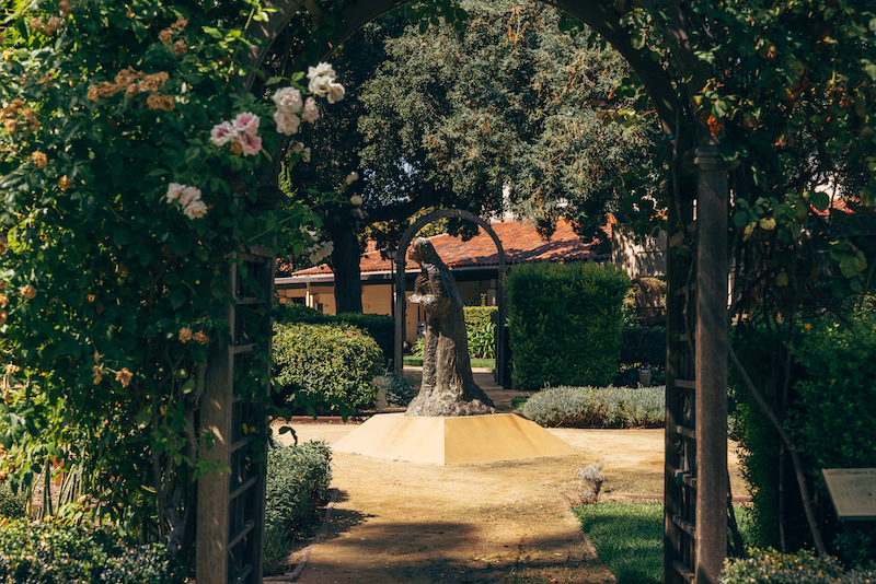A statute of St. Clare in the Saint Clare Garden at Santa Clara University. Photo by Miguel Ozuna